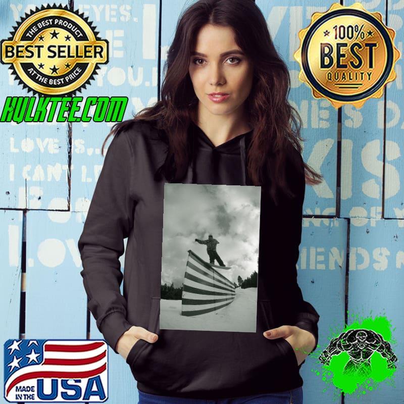 Snowboarder sliding an american flag shirt