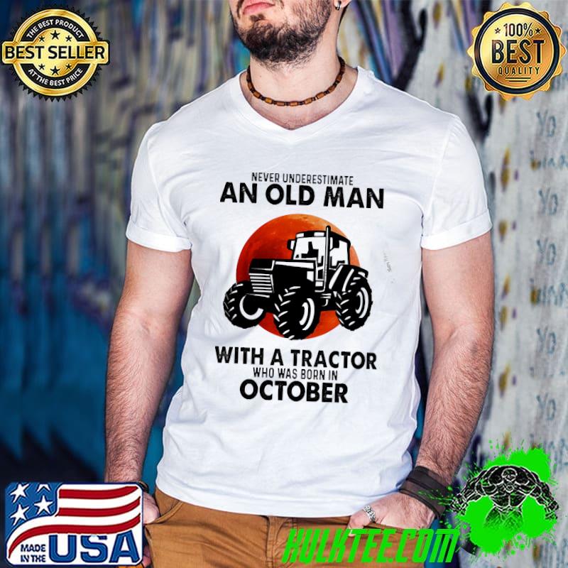 An old man with a tractor who was born in October shirt